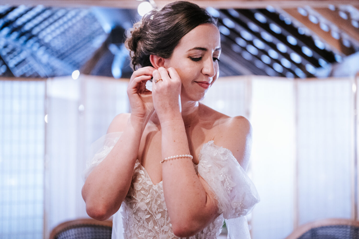 bride adjusting her earring on her wedding day