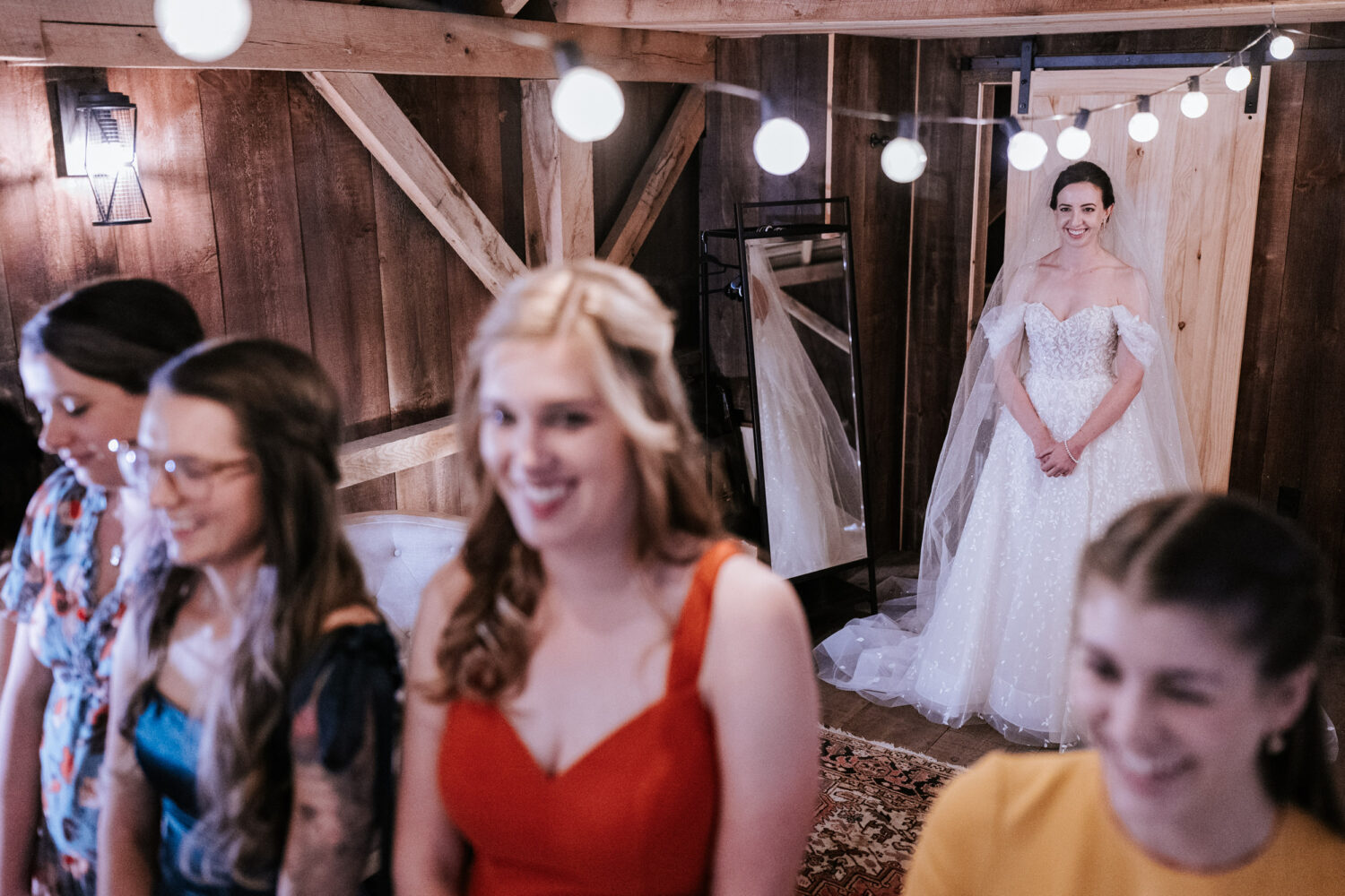 bride waiting to surprise her friends with a first look on her wedding day