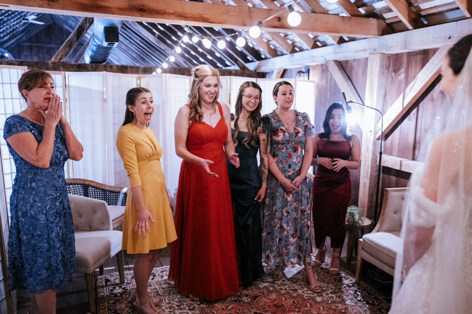 friends of the bride reacting to seeing their friend in her wedding dress on her wedding day