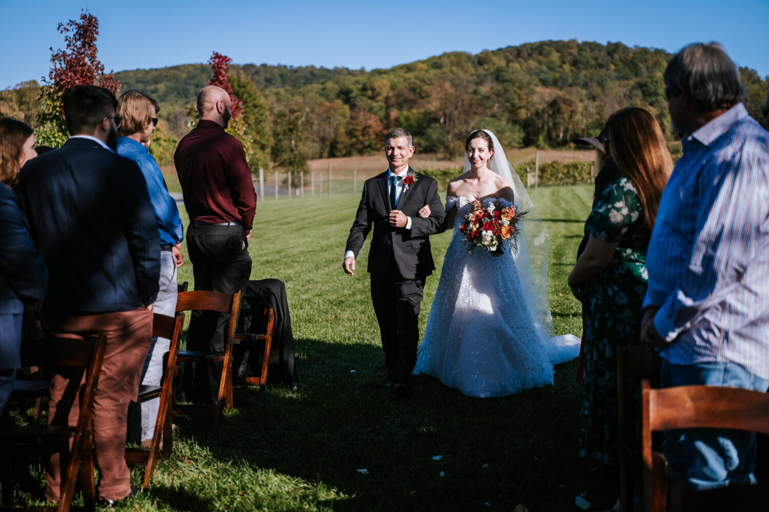 bride walking down the aisle on her wedding day with her father by her side