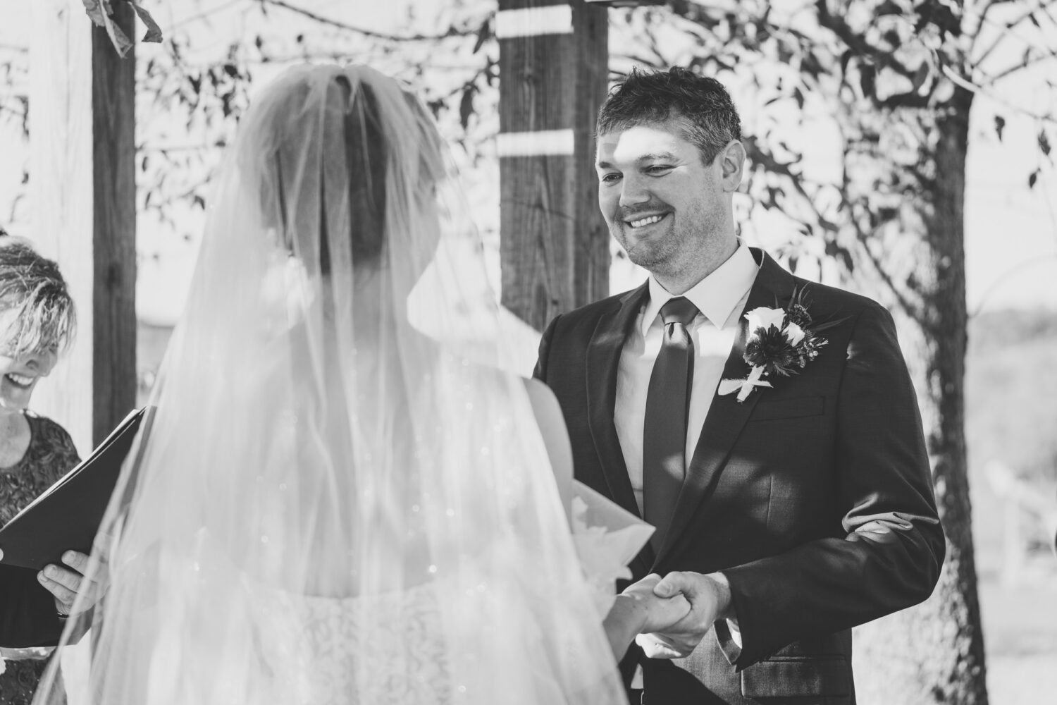 groom smiling while looking at his bride on their wedding day