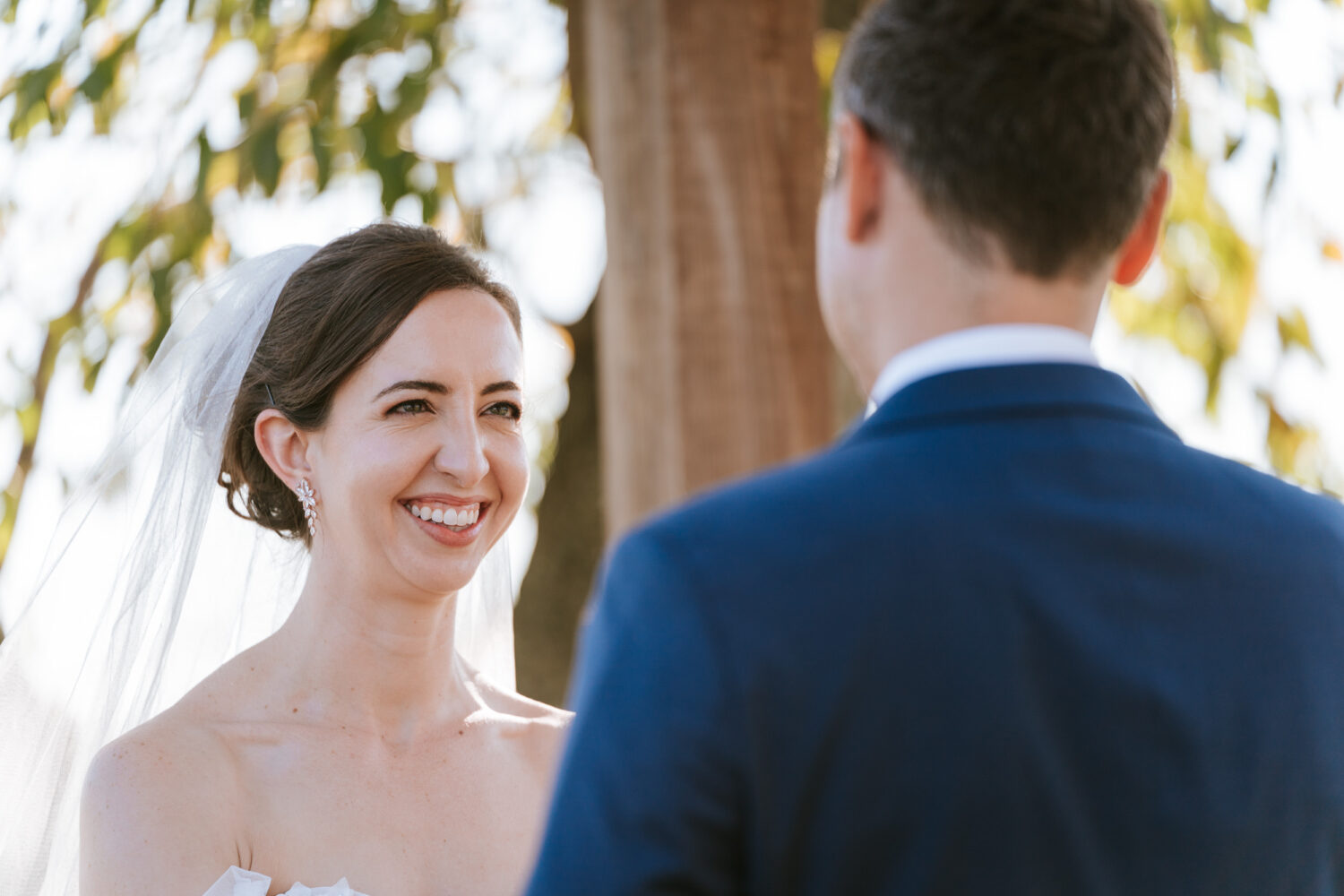 bride smiling while looking at her groom on their wedding day