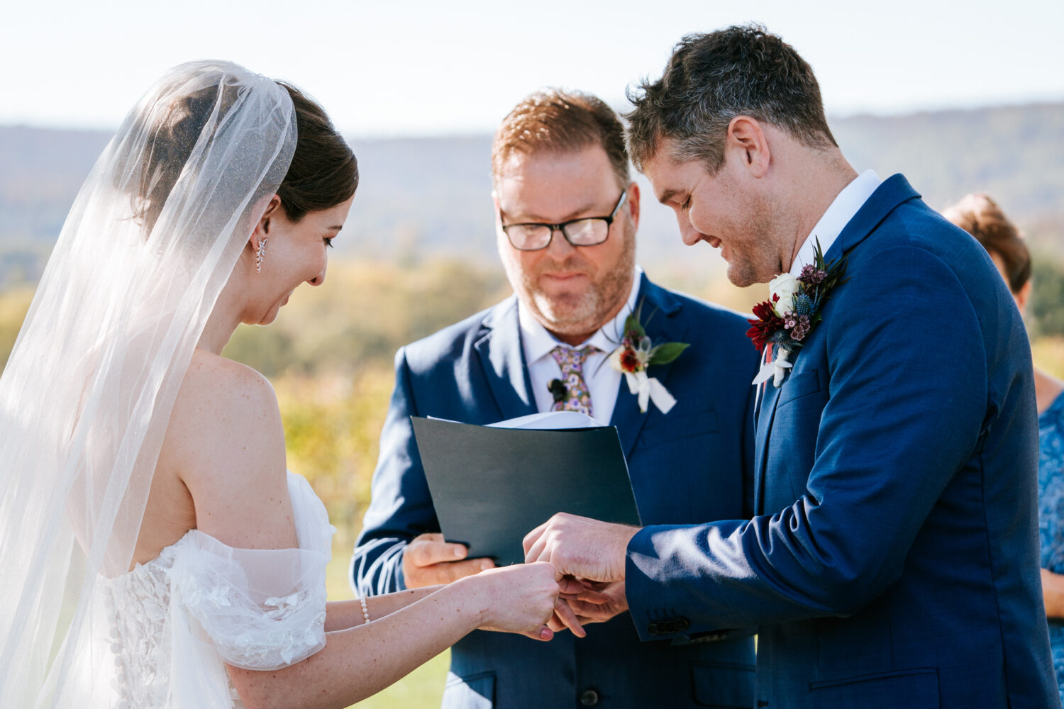 bride and groom exchange rings at their wedding ceremony