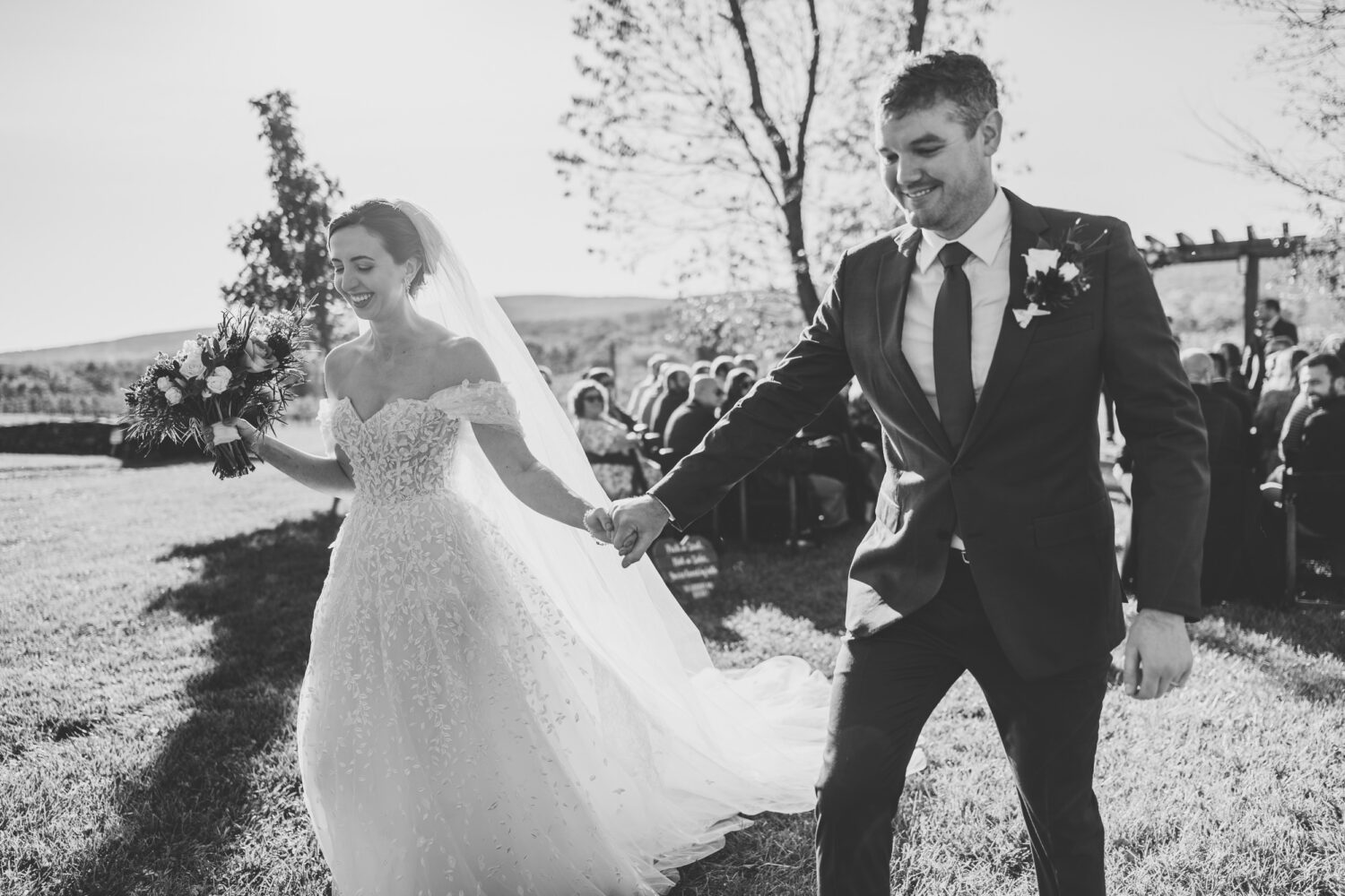 bride and groom exiting their Kalero Vineyard wedding ceremony together