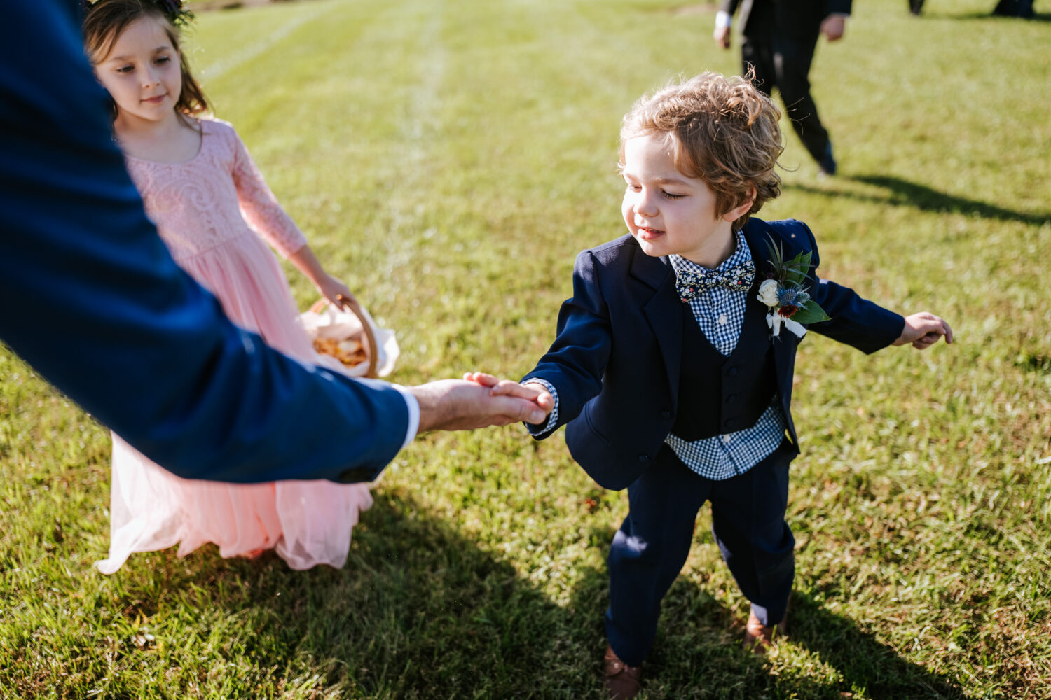 nephew of the groom giving him a high-five at the end of their wedding ceremony