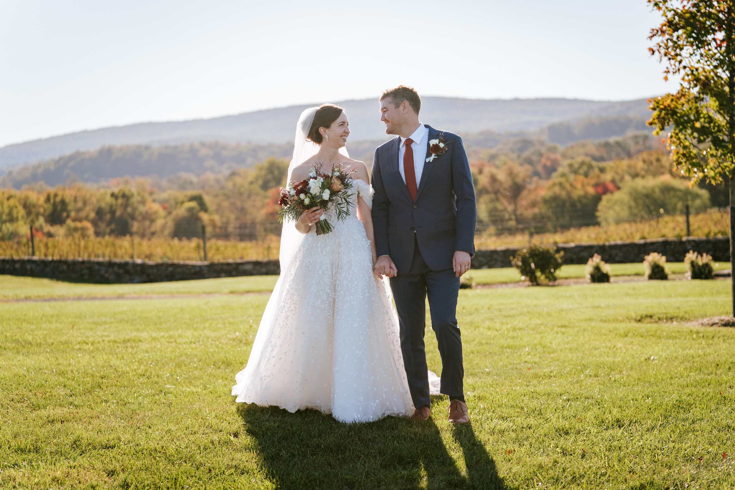 bride and groom walking on their wedding day at Kalero Vineyard in Purcellville, Virginia