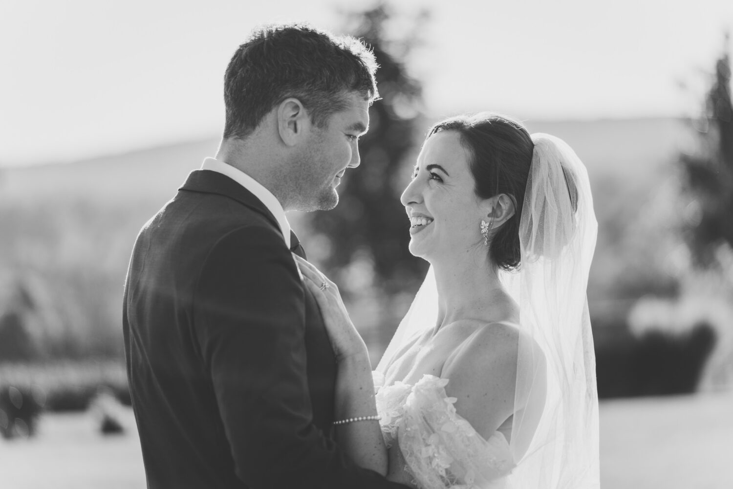 bride and groom looking at each other and smiling on their Kalero Vineyard wedding day