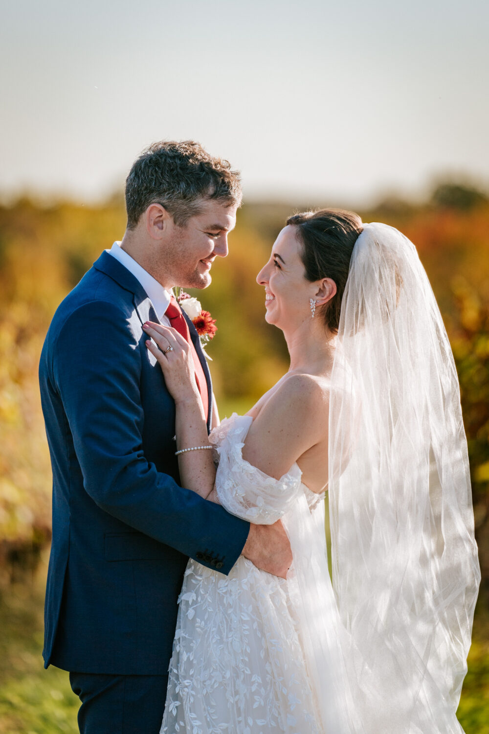 bride and groom looking at each other with acres of land behind them during their Kalero Vineyard wedding