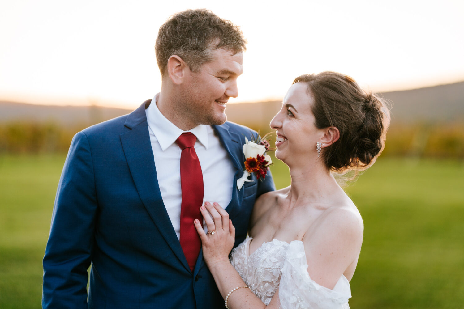 bride and groom smiling and looking at each other on their Kalero Vineyard wedding day