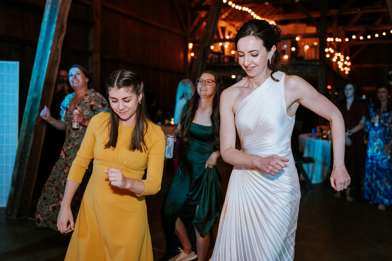 bride dancing on the dance floor with her friends on her wedding day