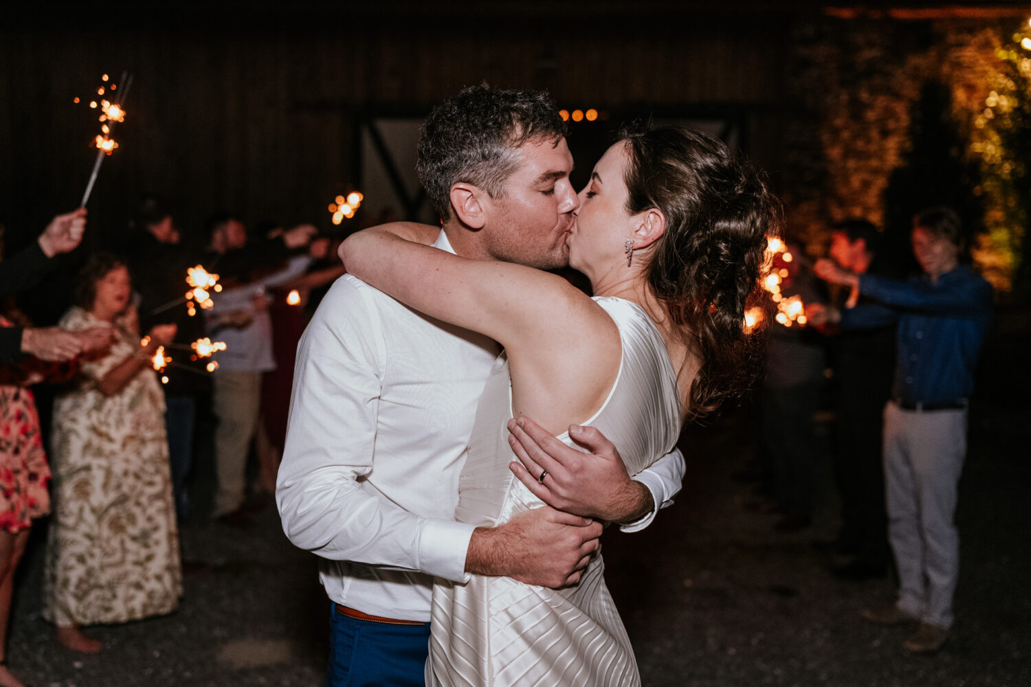 bride and groom kissing during their sparkler exit as they conclude their Kalero Vineyard wedding day