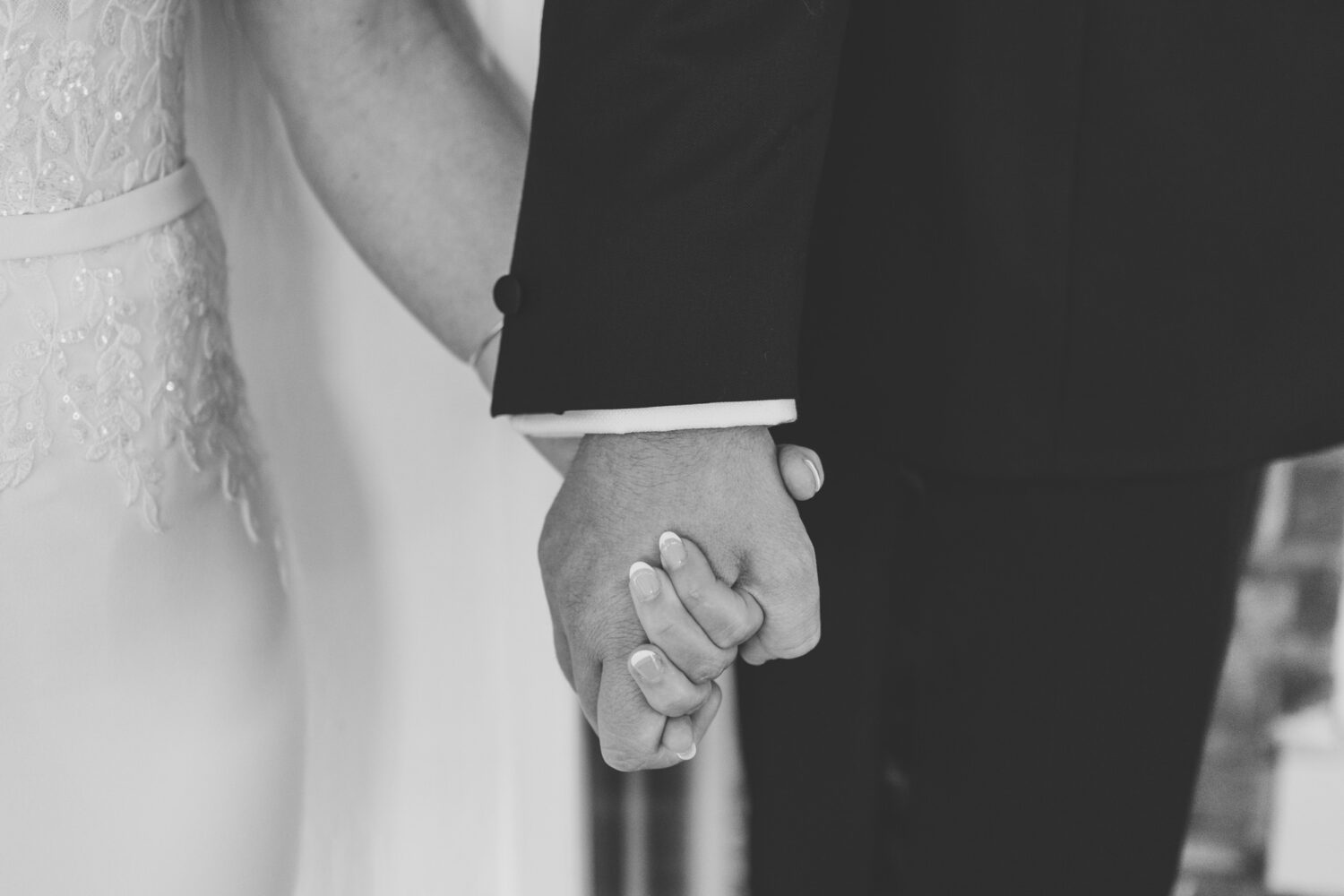 bride and groom holding hands during their first touch