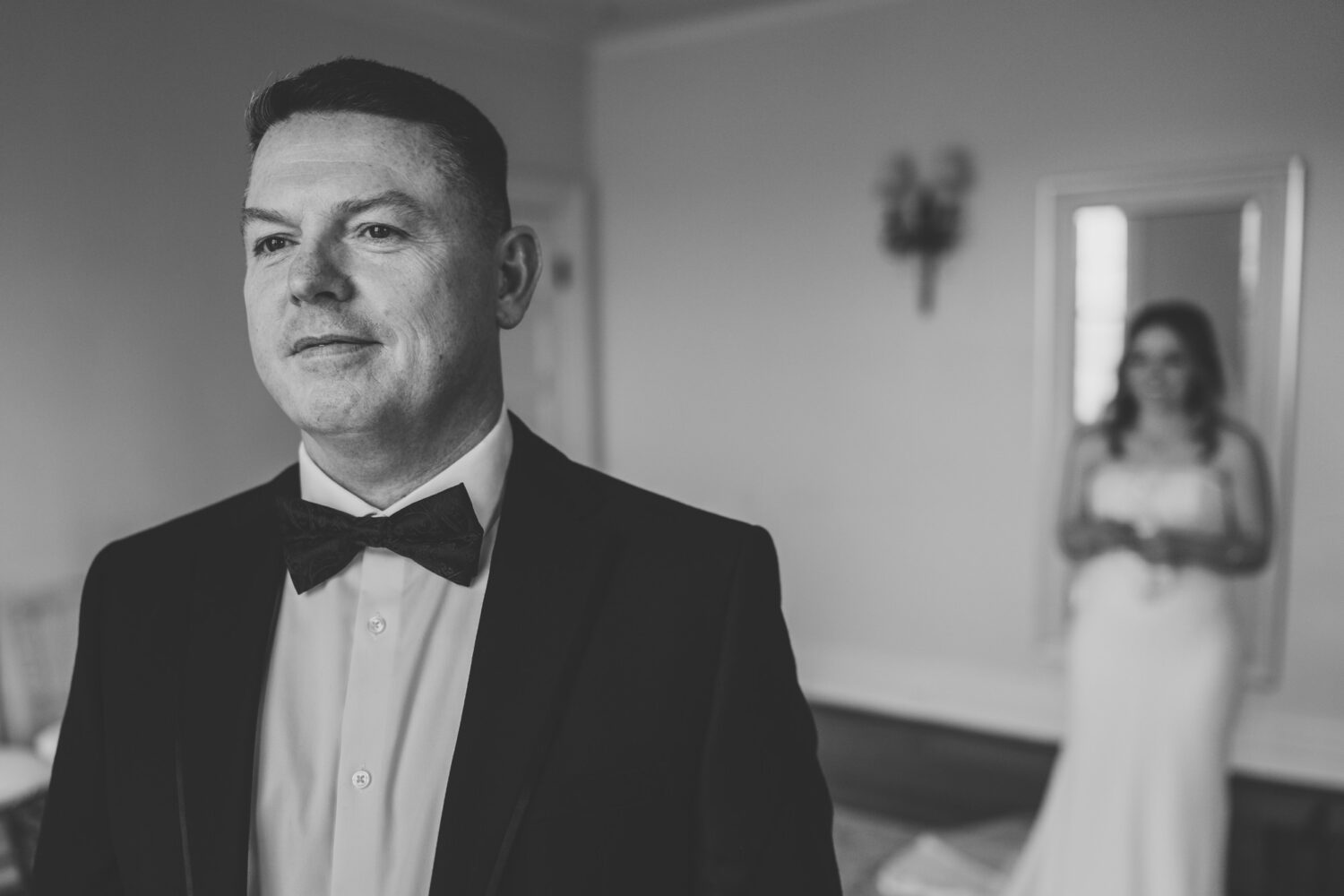 father of the bride getting ready to see his daughter on her wedding day for the first time