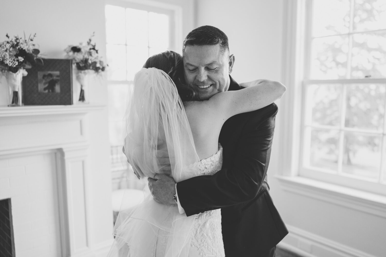 father of the bride and the bride hugging