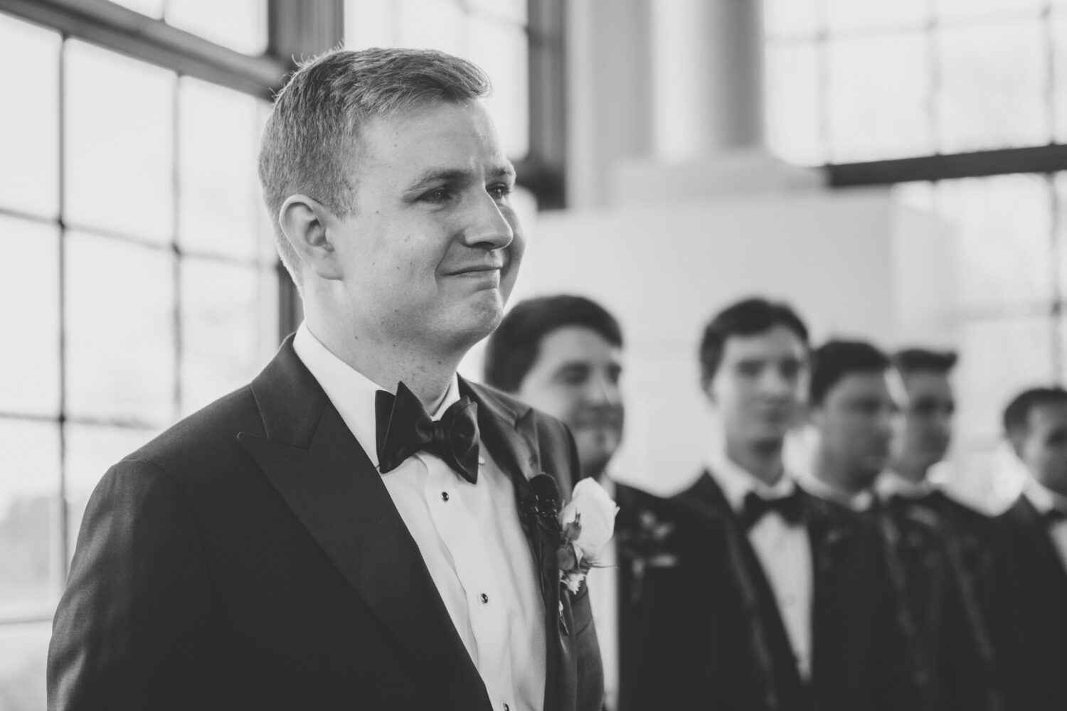 emotional reaction of the groom watching his bride walk down the aisle