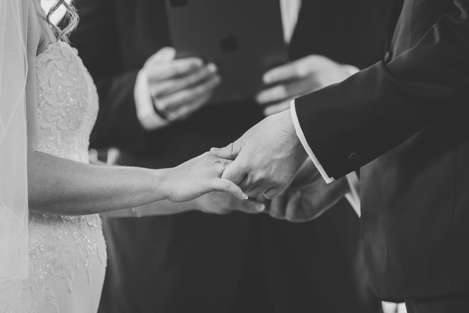 bride and groom holding hands during their wedding ceremony