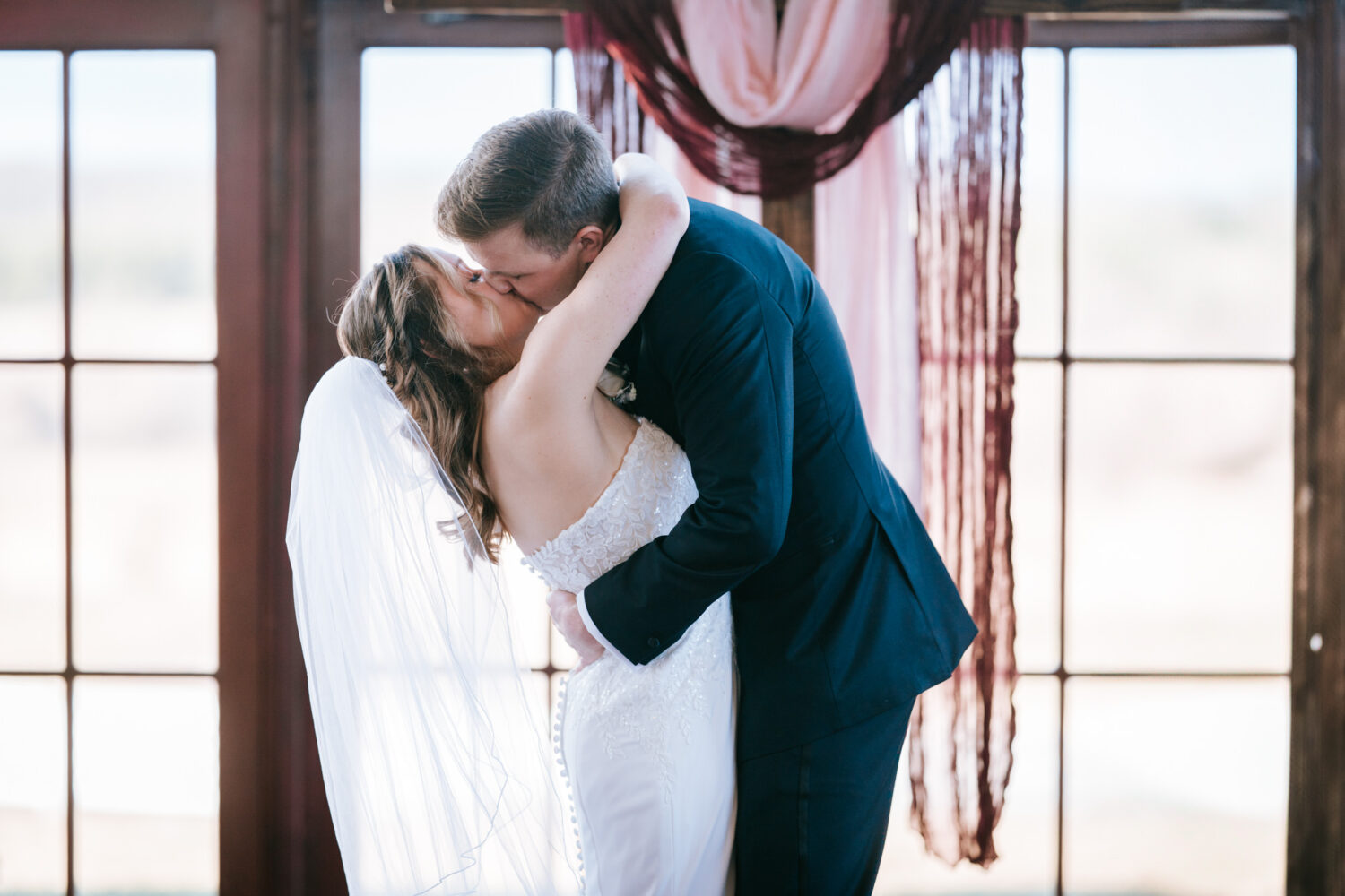 bride and groom first kiss