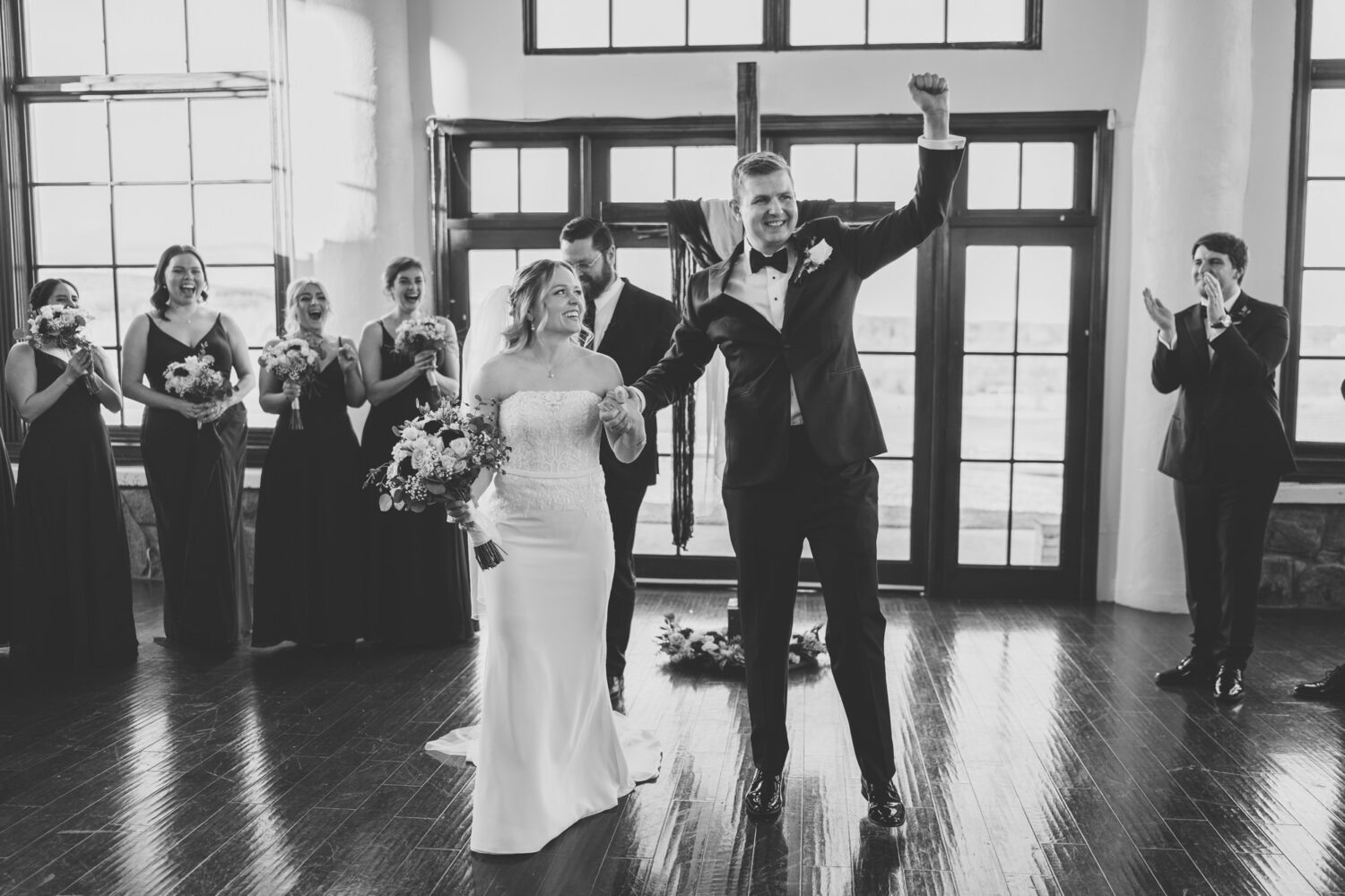 bride and groom happy and cheering as they exit their ceremony space