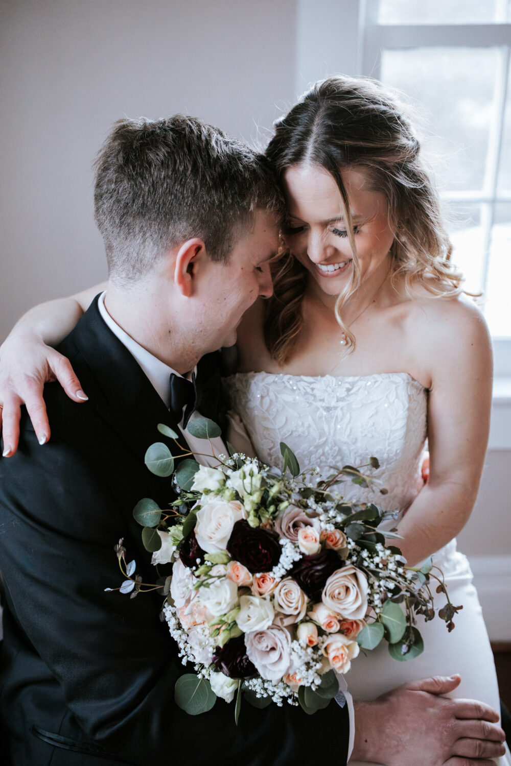 bride and groom interacting and smiling together on their wedding day