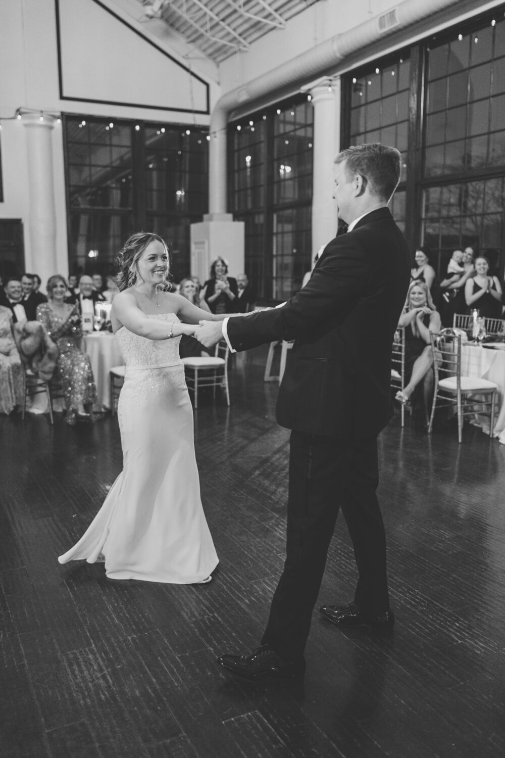 groom spinning bride during their first dance