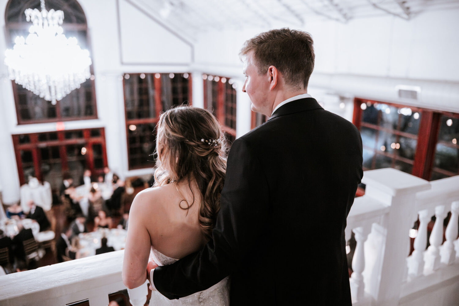 bride and groom portrait while staring off into their wedding reception