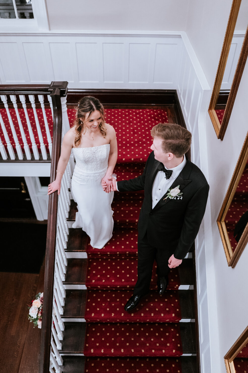 bride and groom walking down stairs together