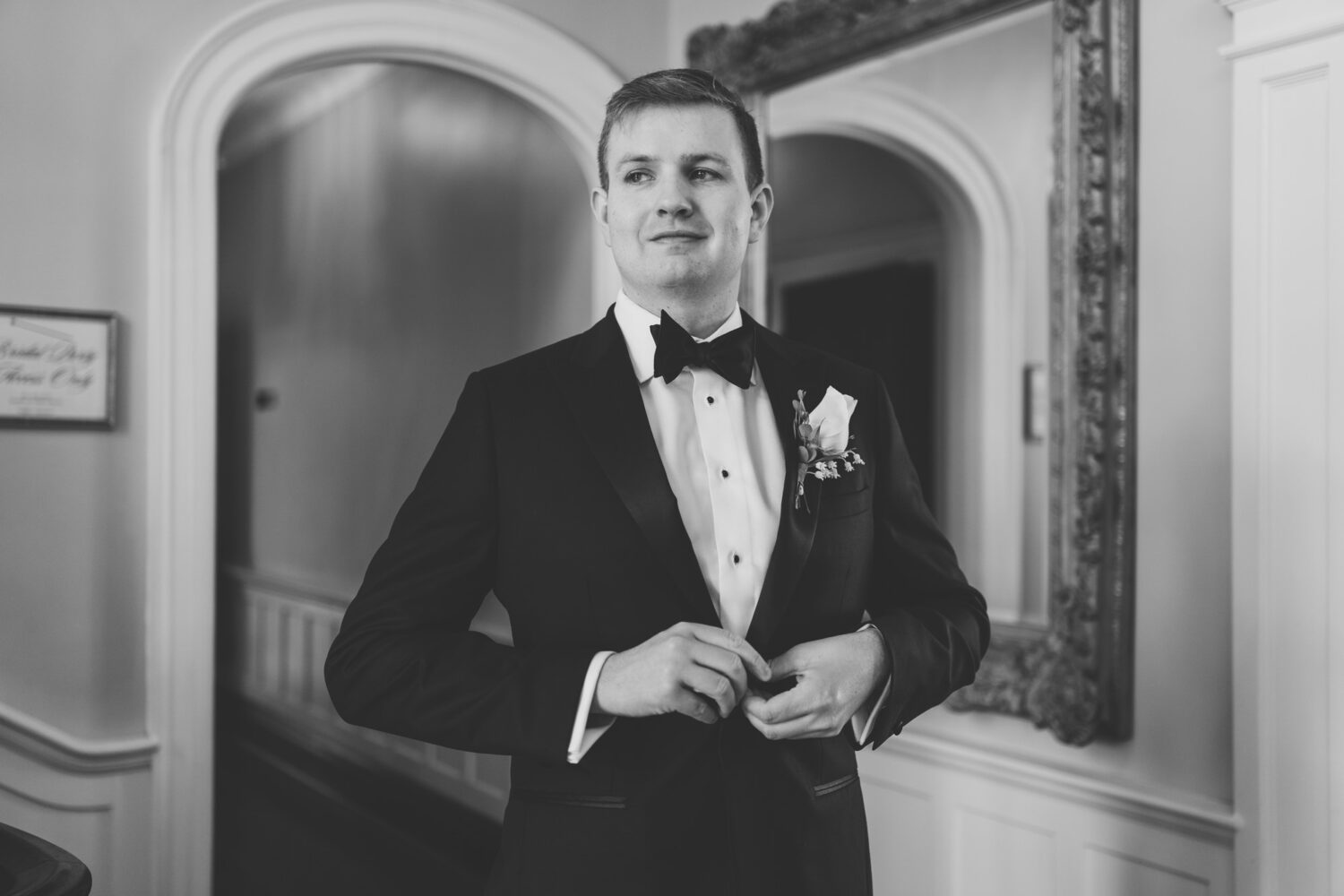 groom fixing his jacket on his wedding day