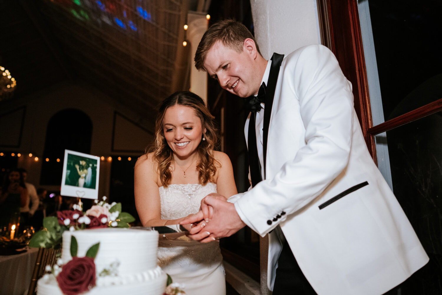 bride and groom cutting their wedding cake together