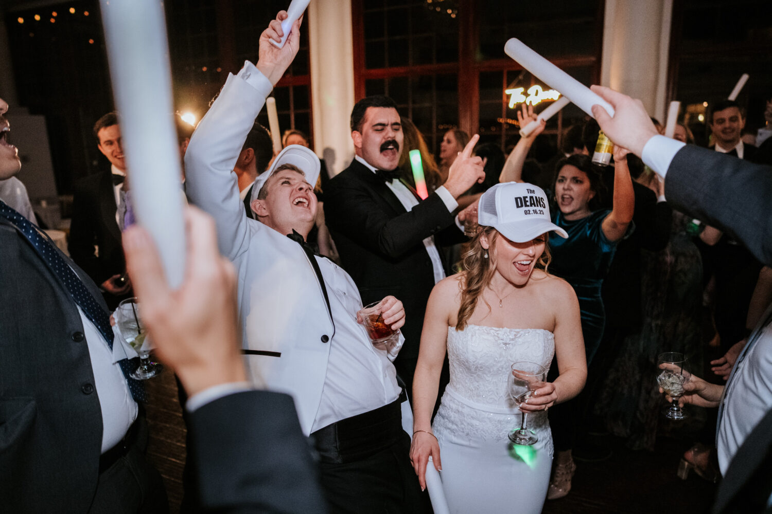 bride and groom dancing together with their wedding guests