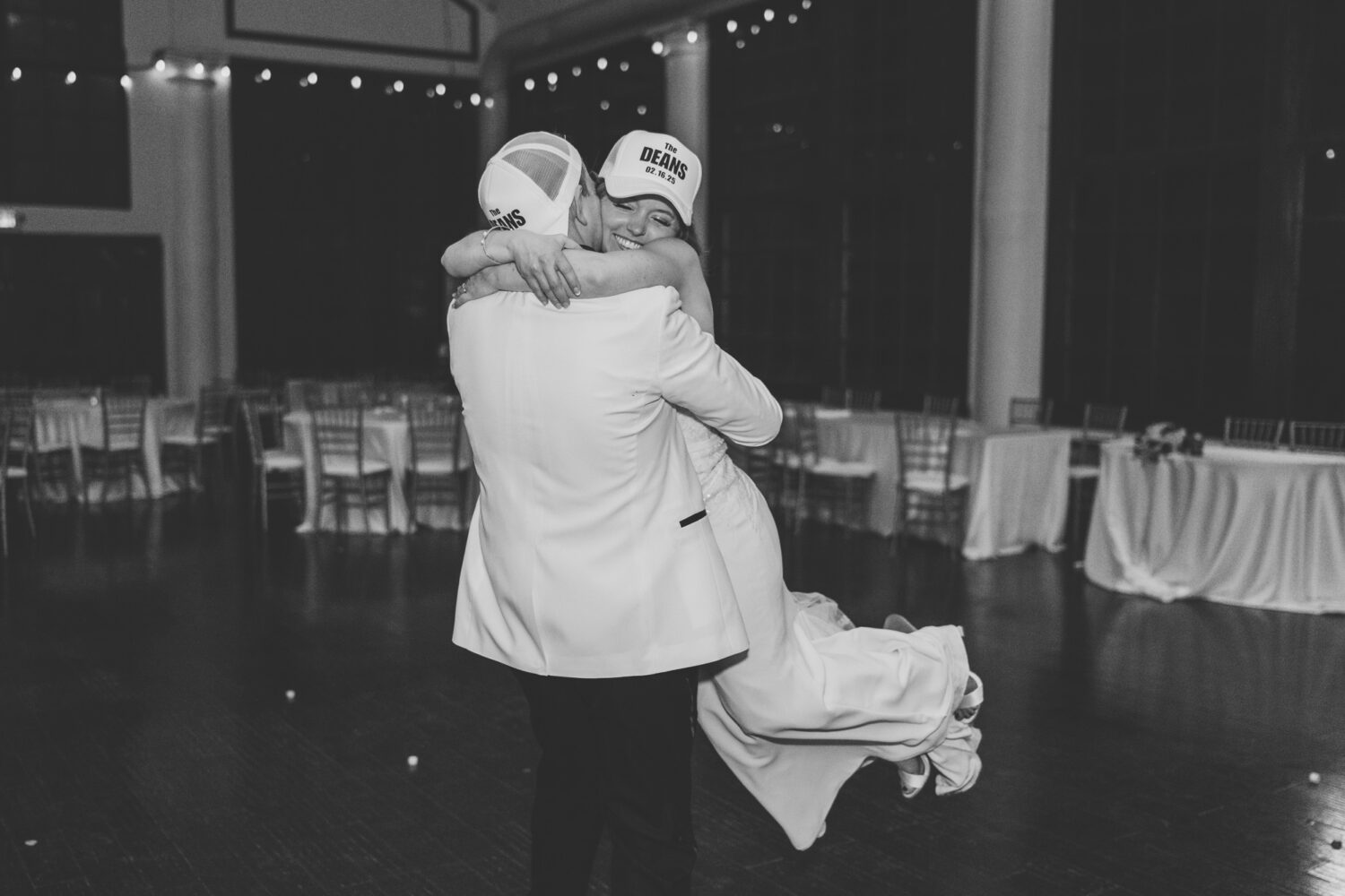 groom picking up his bride and spinning her during their private last dance