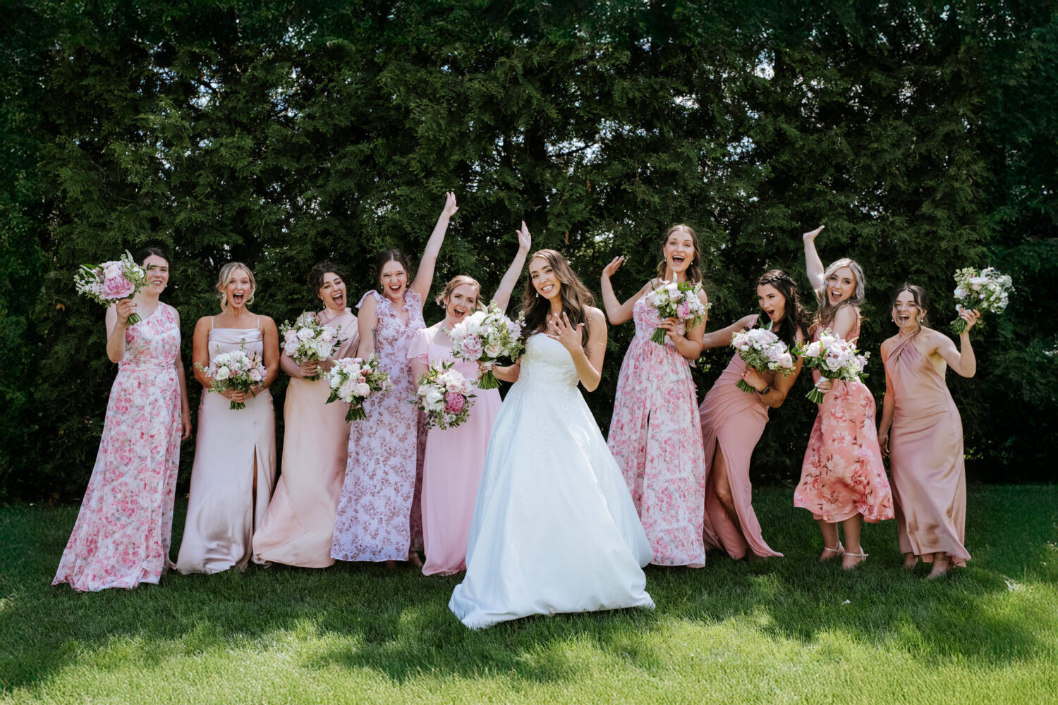 bridesmaids happy and excited while the bride shows her wedding ring