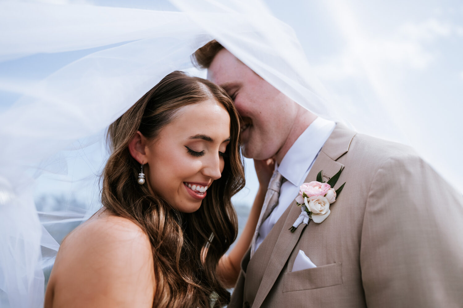 bride and groom portrait underneath the bride's wedding veil