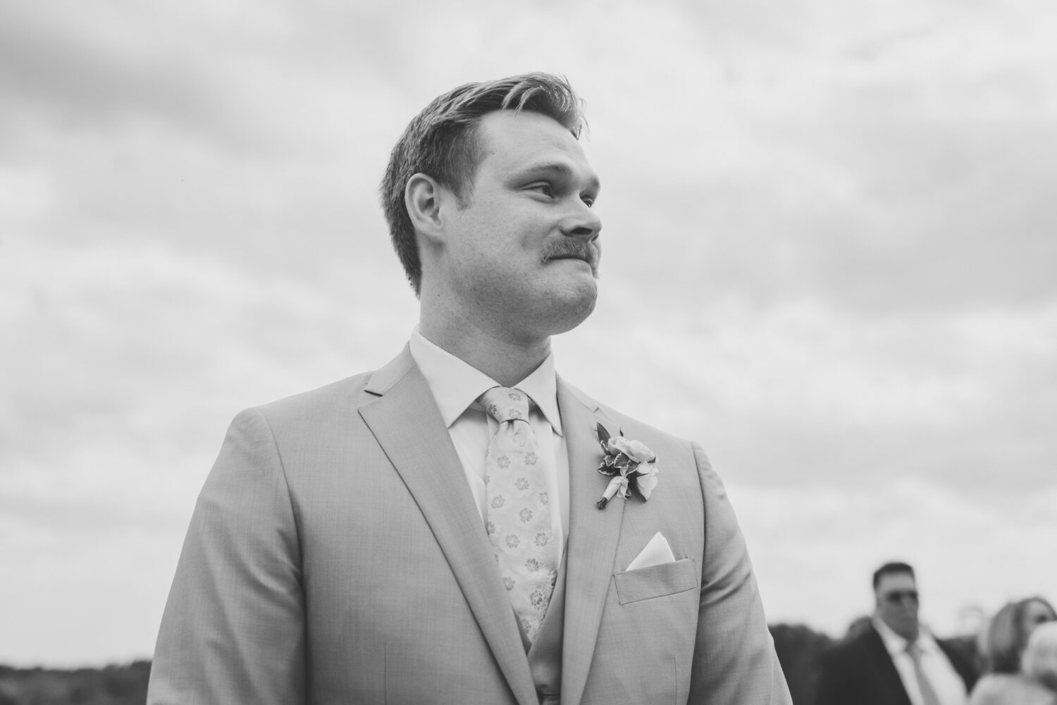 groom emotional while seeing his bride walk down the aisle