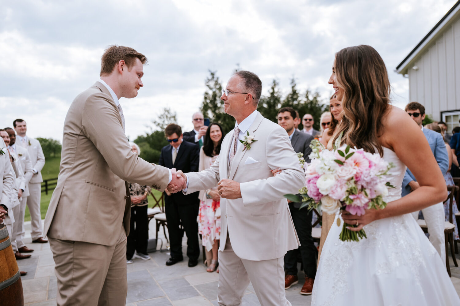 groom shaking his bride's father's hand