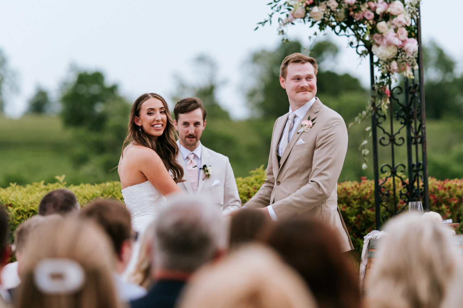 bride and groom looking at their wedding guests during their wedding ceremony