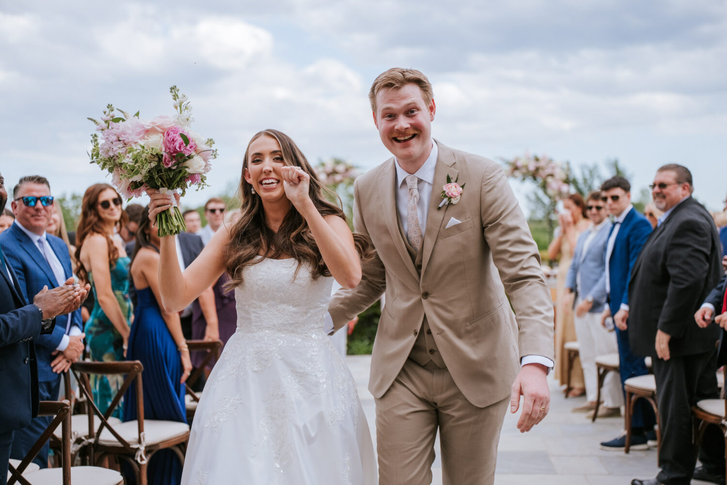 bride and groom excitedly leaving their wedding ceremony