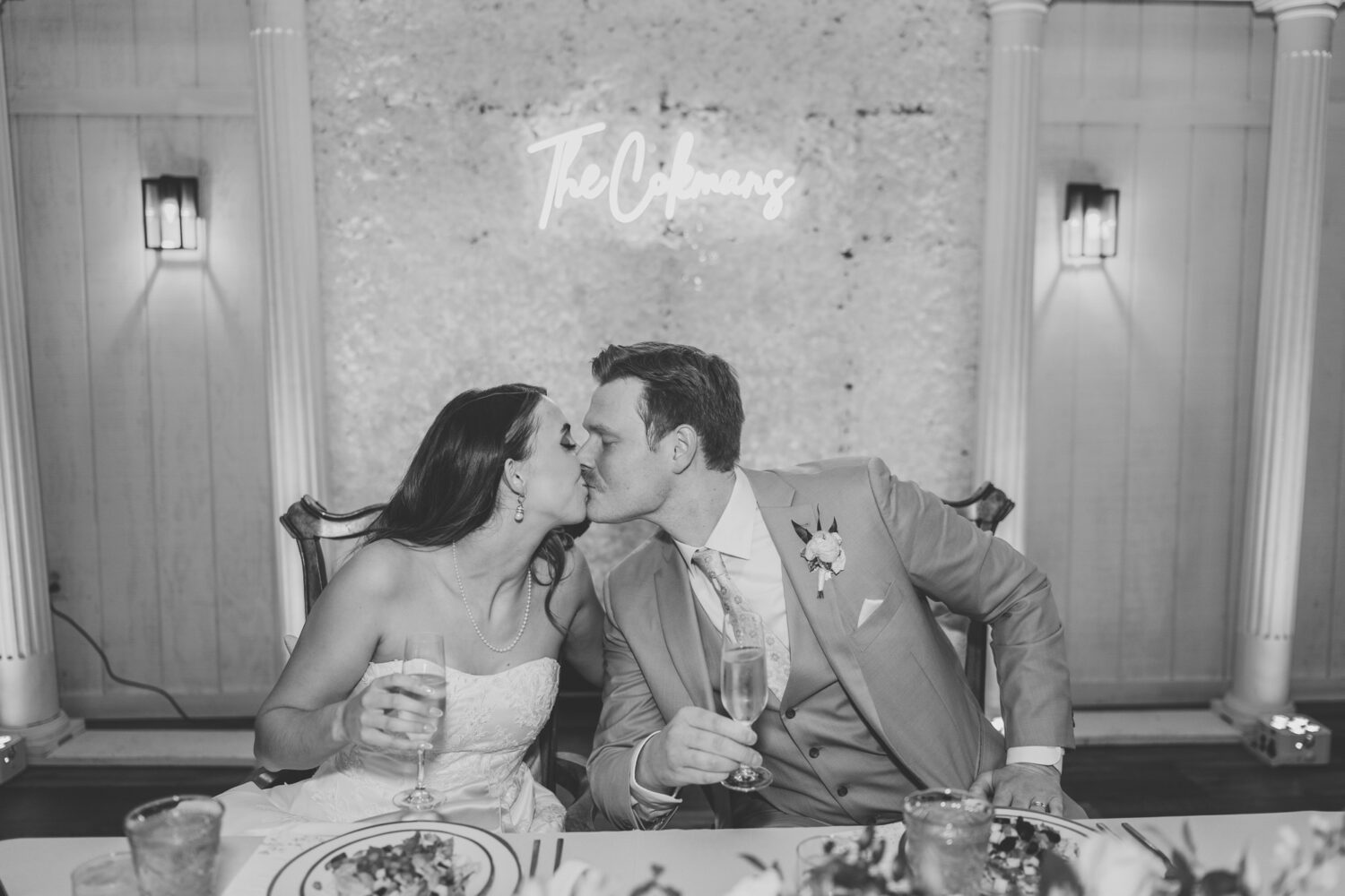 bride and groom kissing at their sweetheart table
