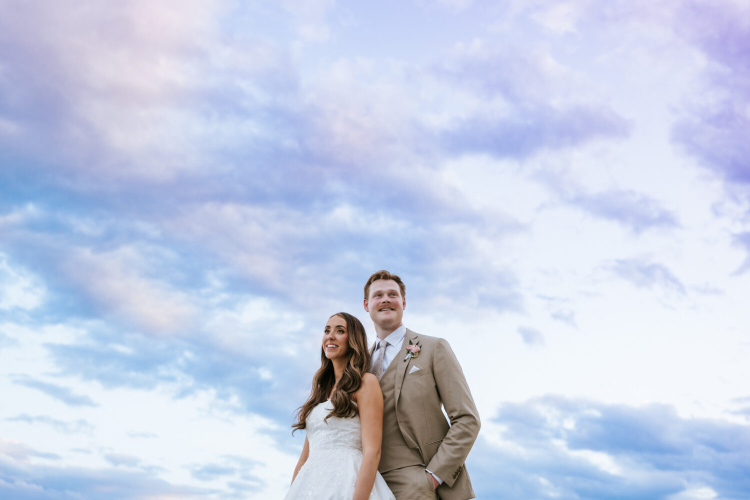 bride and groom creative portrait with the sky in the background