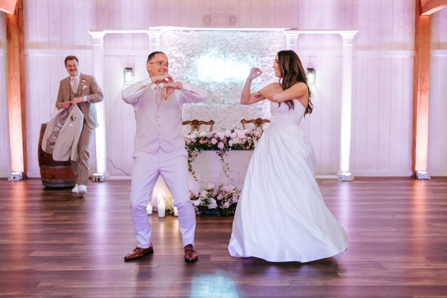 bride and father of the bride dancing together