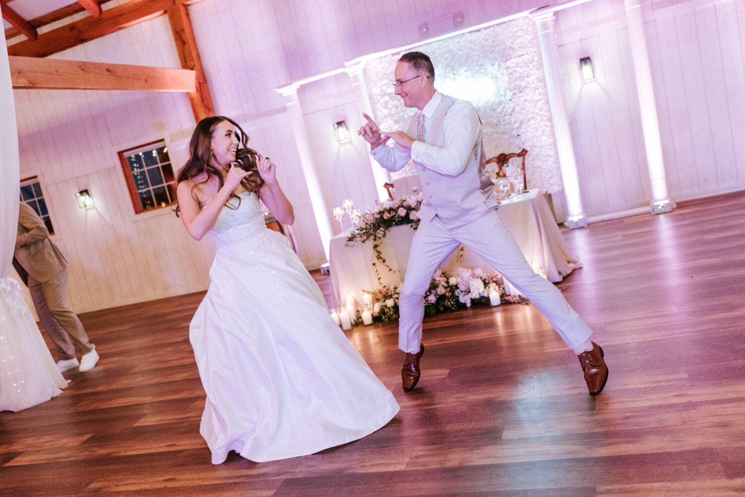 bride and father of the bride sharing a fun dance together