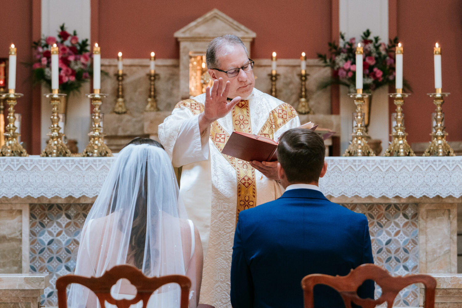 priest addressing the bride and groom during their church wedding ceremony