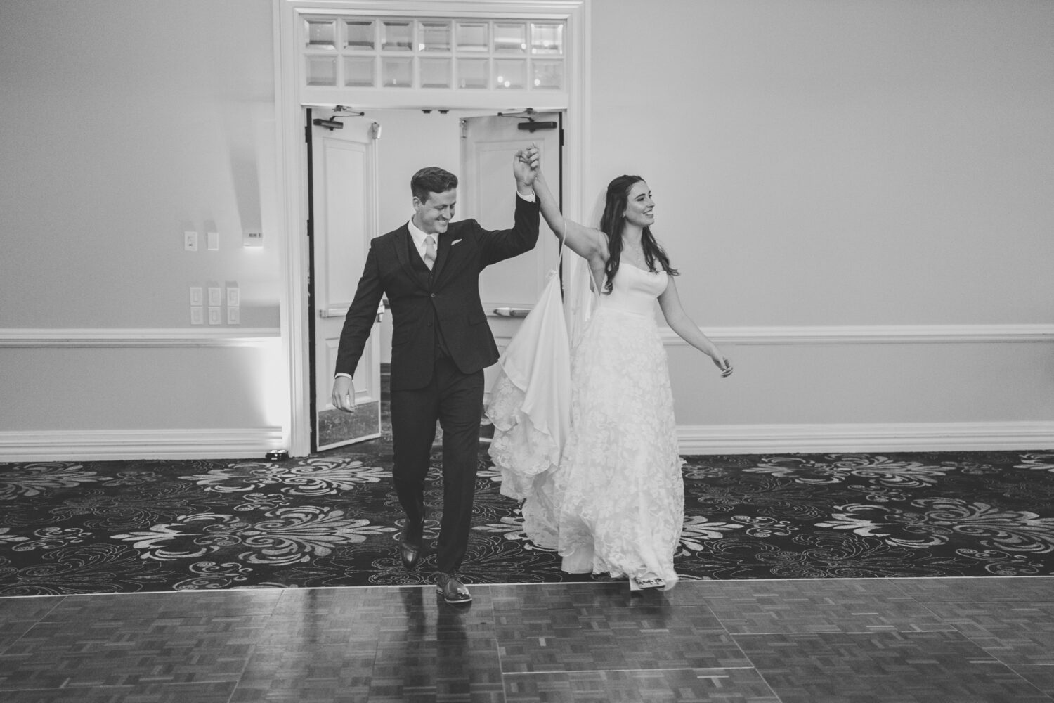 bride and groom entering their lansdowne resort wedding reception