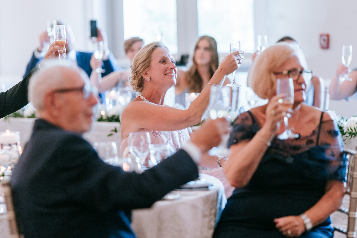 wedding guests smiling while listening to the welcome speech