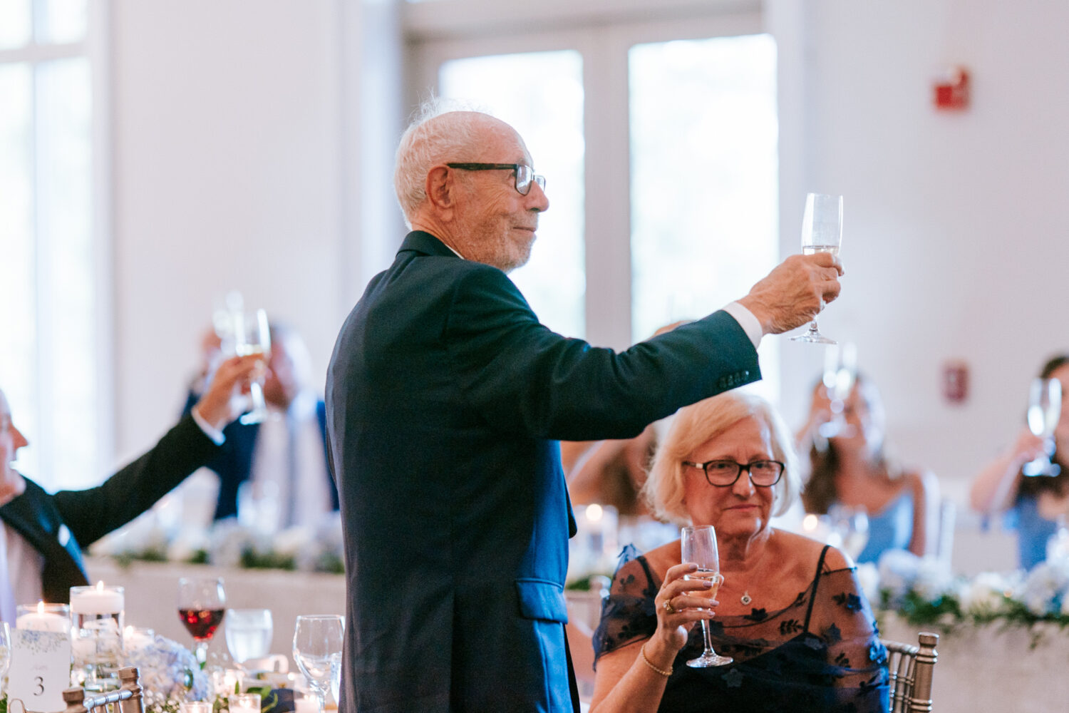 grandfather of the bride smiling while listening to the welcome speech