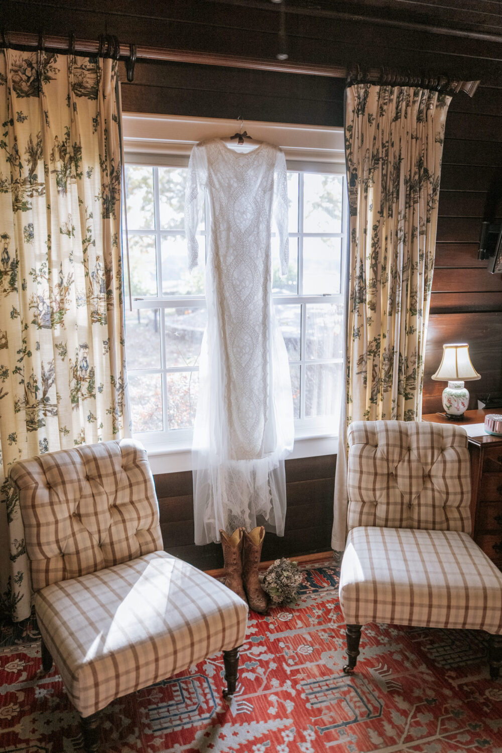 Bride’s wedding dress hanging up in Goodstone Inn suite
