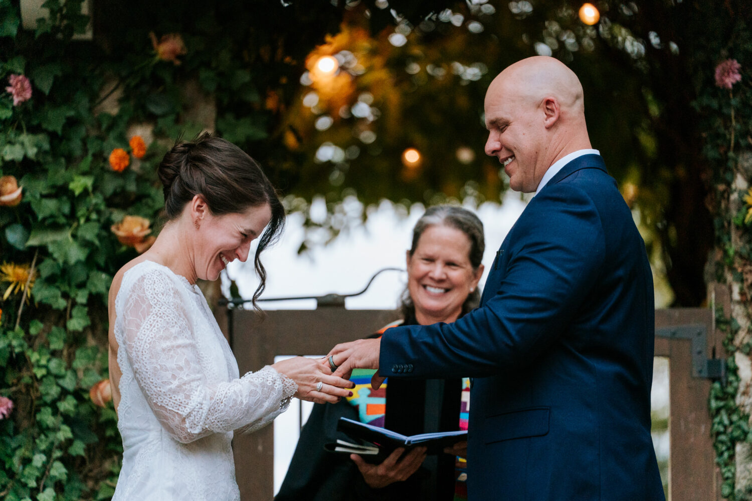 Bride and groom exchanging wedding rings at the altar