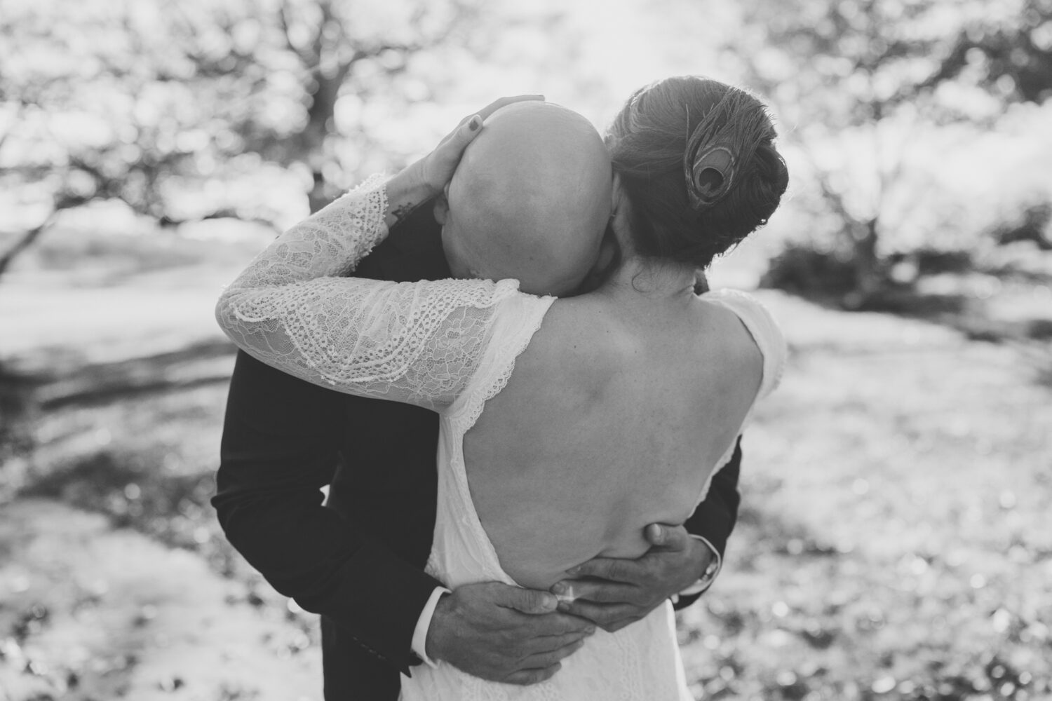 Groom hugging bride with emotion during their first look