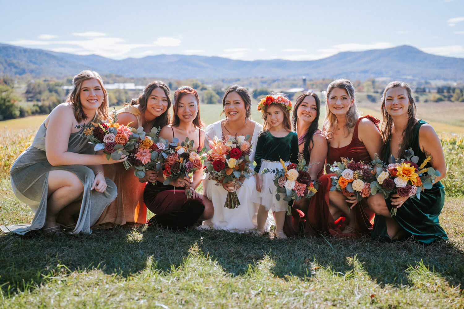 Bridal party smiling with colorful bouquets at fall Shenandoah Woods wedding
