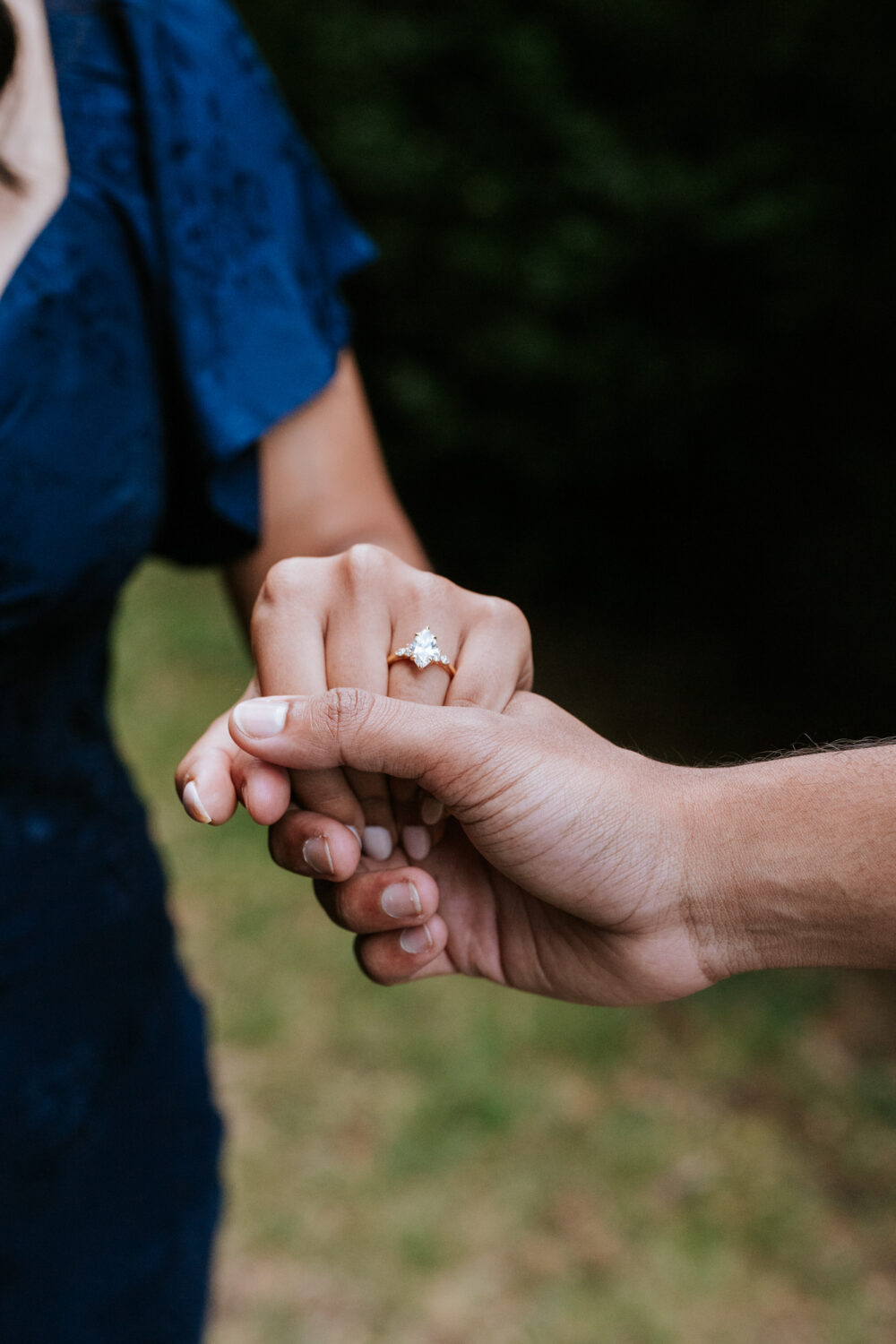 Close-up of couple holding hands showing engagement ring after a surprise proposal in Leesburg, VA.