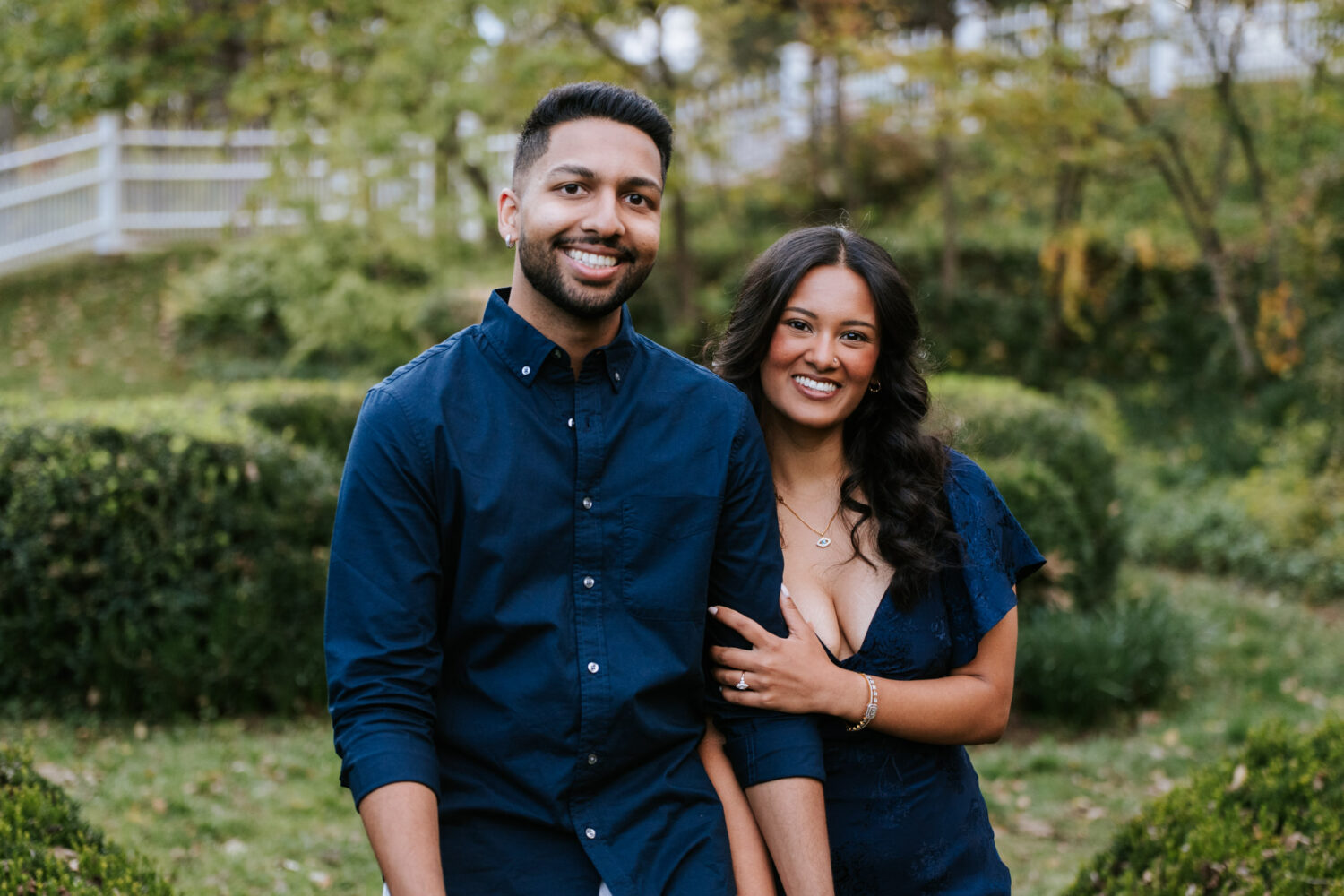 Newly engaged couple smiling together in the garden at Oatlands Historic House & Gardens in Leesburg, Virginia.
